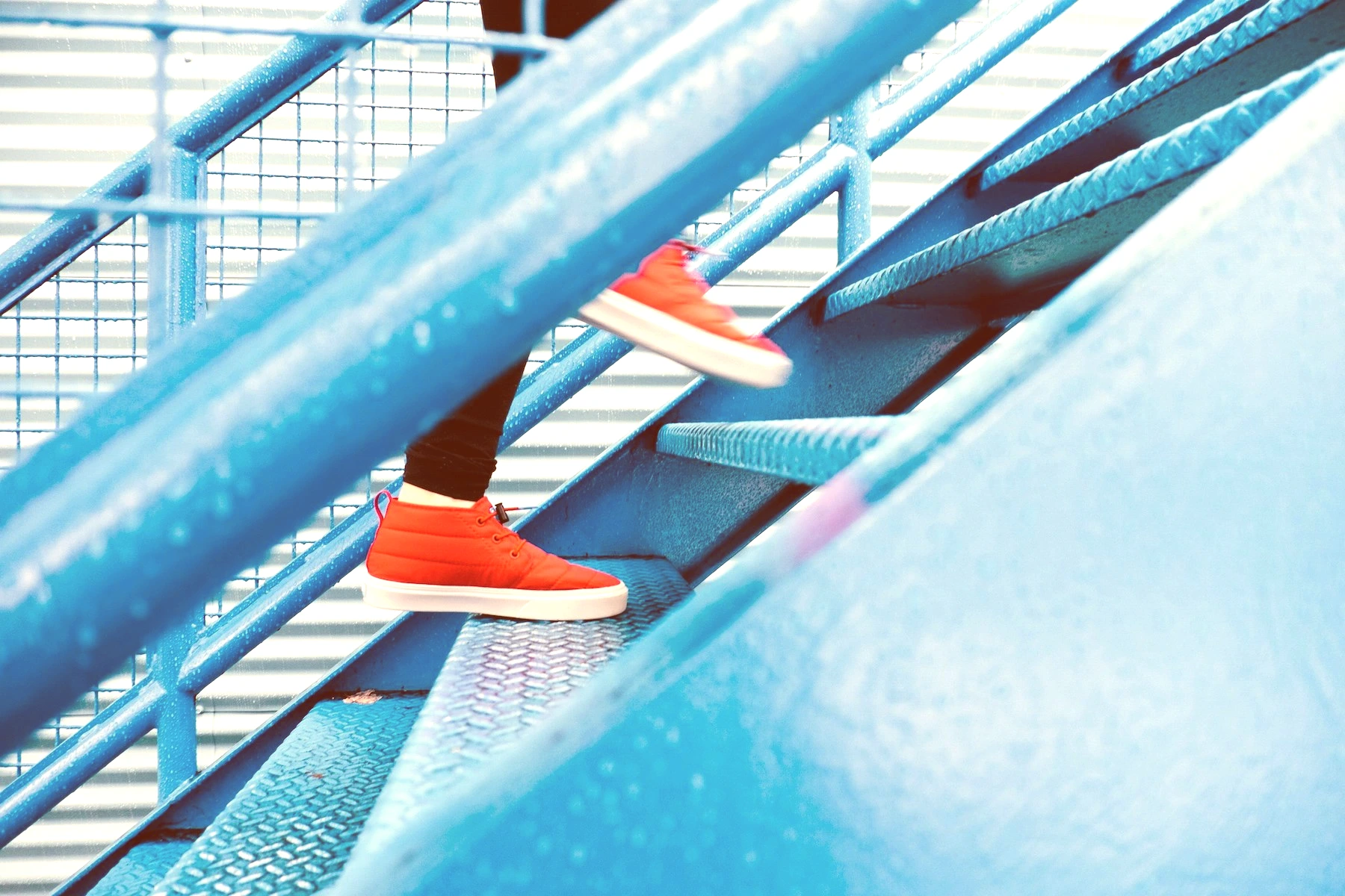 person stepping on blue stairs